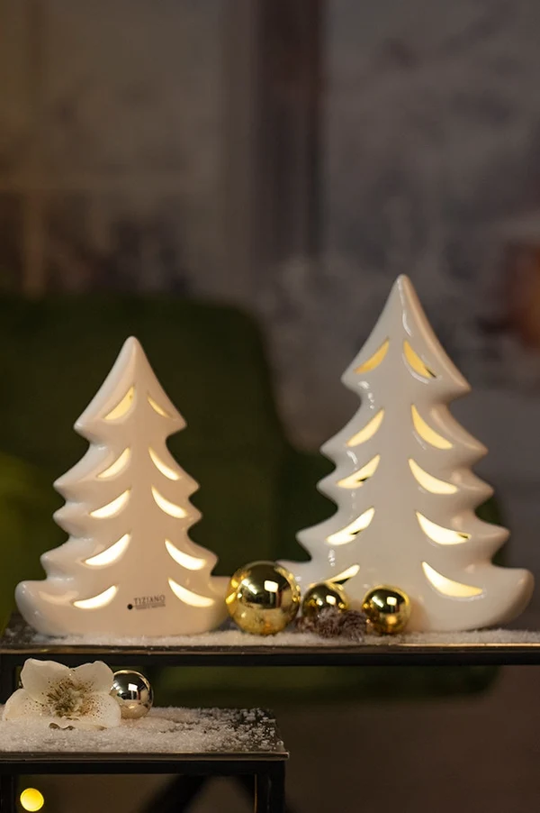 white ceramic trees, christmas decor, gold ornaments, snowy surface, plateau display