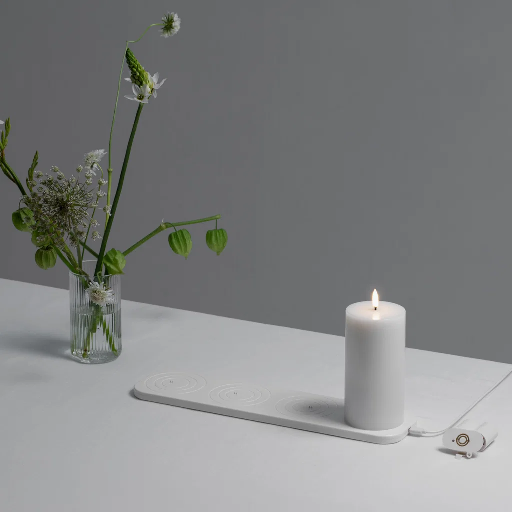 vase, flowers, candle, electric candle warmer, flat white surface